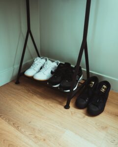 "White sneakers on wooden floor"
