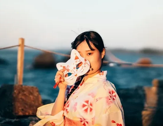 Traditional Japanese jūnihitoe — a Heian period noblewoman wearing multi-layered silk court robes with seasonal colour gradations